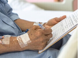 close up view of patient signing consent paperwork