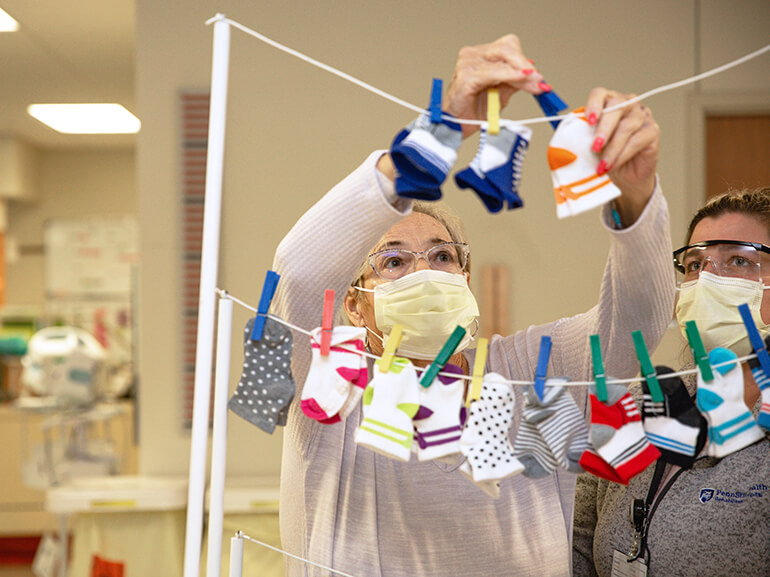female patient hanging socks as part of occupational therapy
